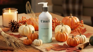 Uzari U-Wash bottle on a Thanksgiving-themed table with pumpkins and candles, featuring a 30% discount code.